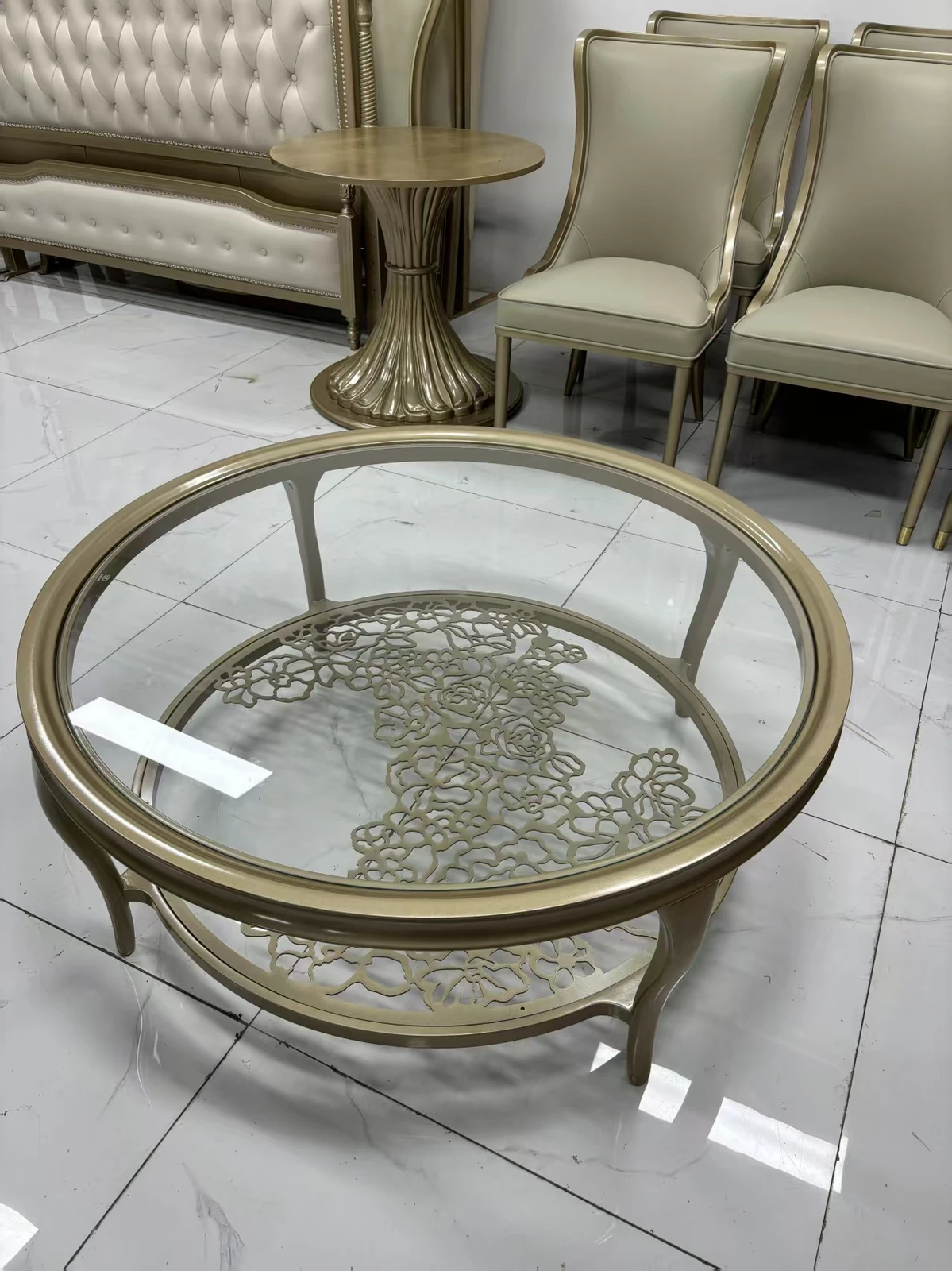 Gold round glass coffee table with floral design